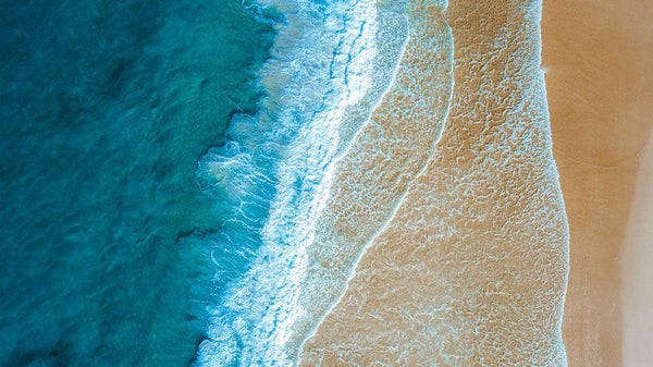 aerial view of ocean water and sand