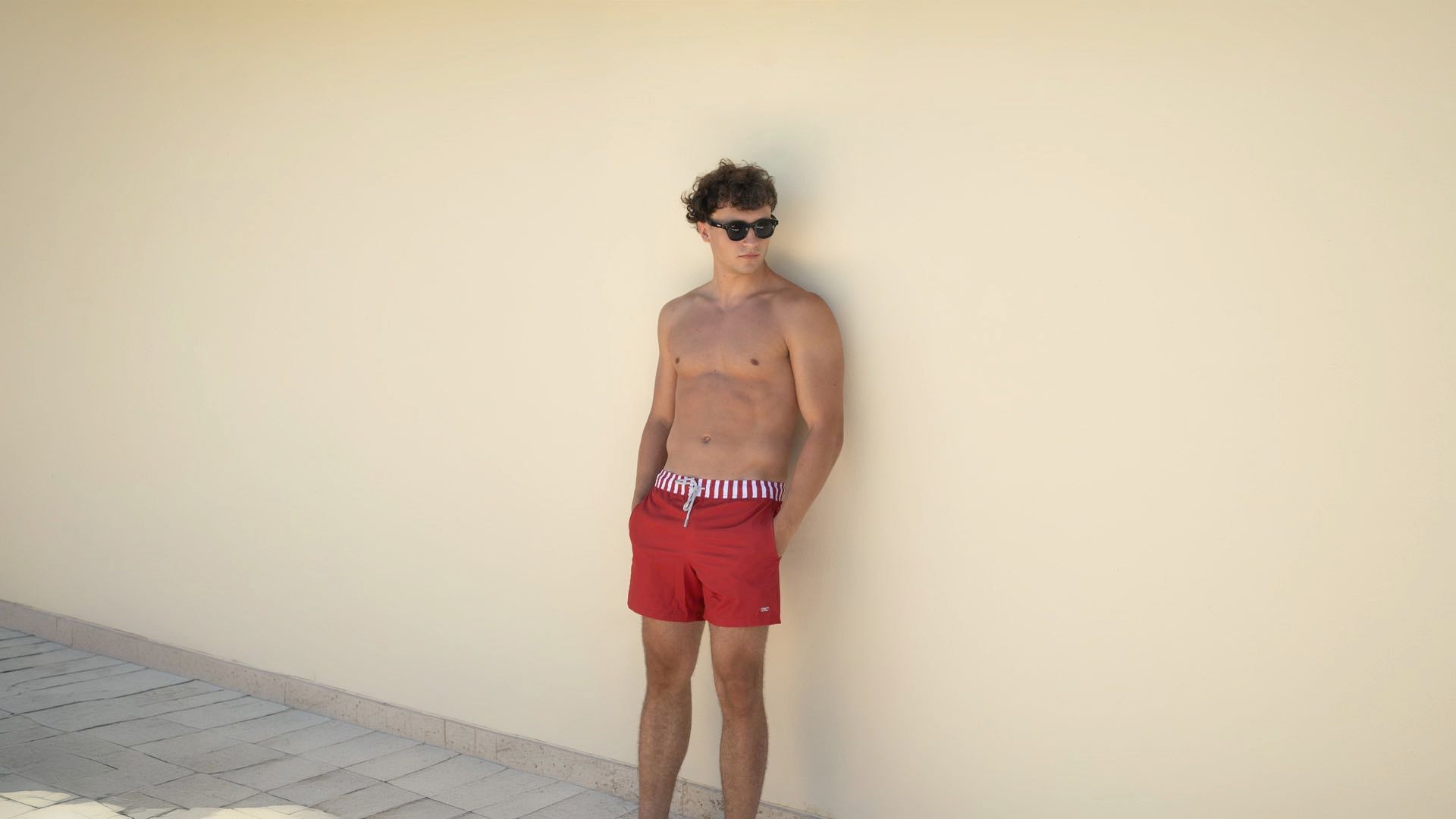 men wearing red arlequin swim trunk