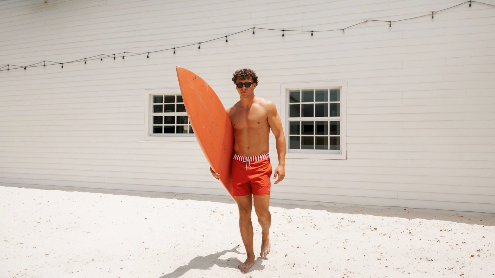 Men wearing red arlequin swim trunk