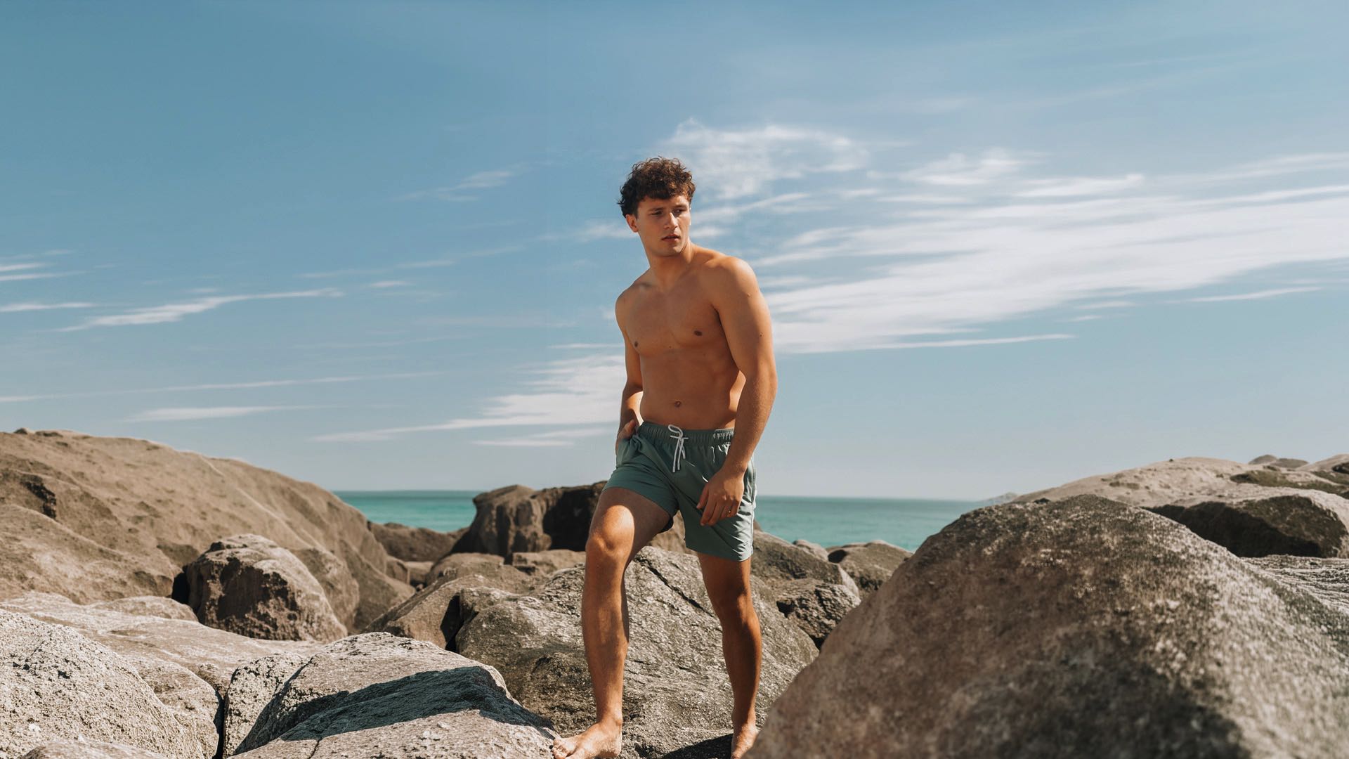 men wearing olive swim trunk